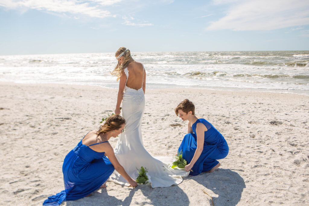 St. Pete Beach Elopement Bridesmaids Photography fixing wedding dress