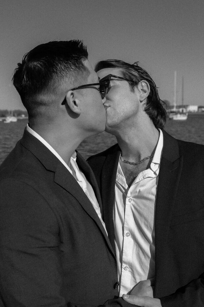 McCoy and Travis smooching on their elopement day in Davis Islands Beach, Fl. wedding photographer Cecetay Productions