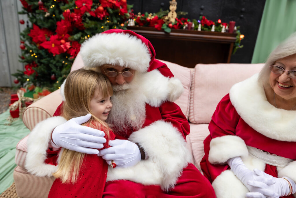 Santa Pete hugging girls hello for the first time this Christmas season