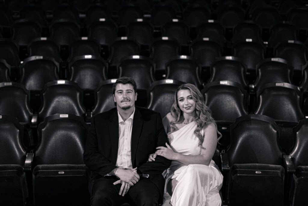 Bride and groom sitting in the front row of seats in the tampa theatre for their engagement session with CeceTay Productions.