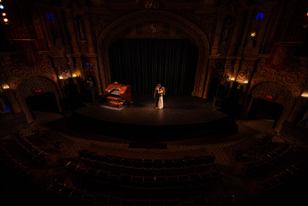 Couple dancing on the stage at the tampa theatre for engagement session with CeceTay Productions