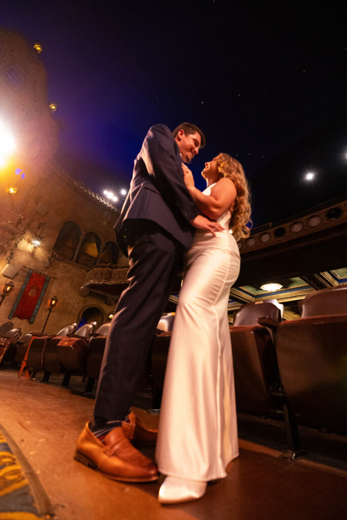 Couple admiring each other while CeceTay Productions captures a professional picture of them with the iconic ceiling of the Tampa Theatre.